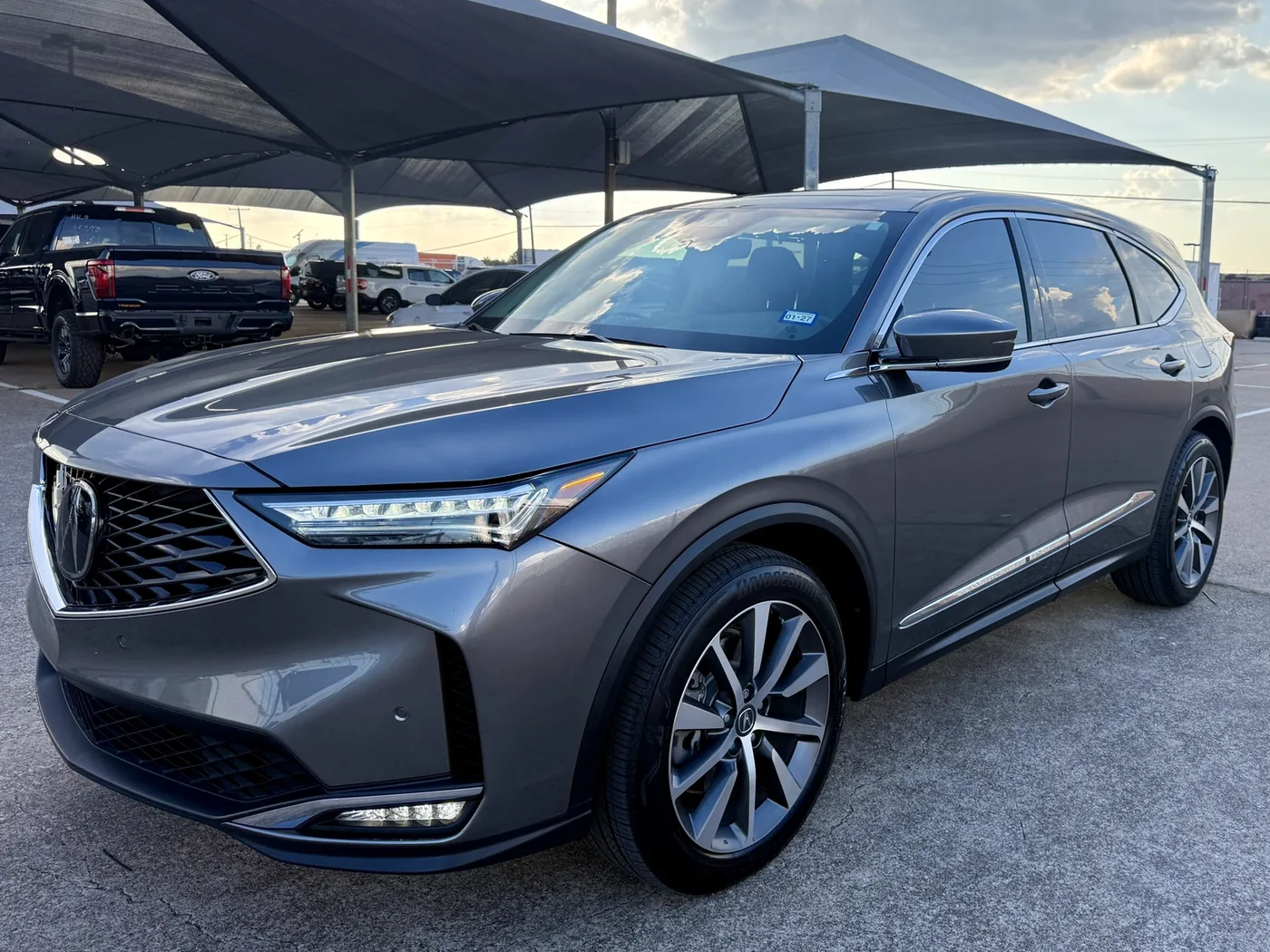 Gray Acura SUV photographed at sunset